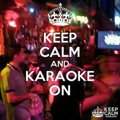 a poster with the words keep calm and karaoke on in front of a group of people