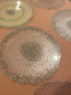 three circular trays on top of a table covered in silver and gold glitter dots