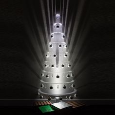 a lit up christmas tree sitting on top of a table