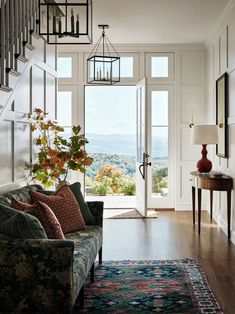 a living room filled with furniture and a stair case