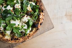 a pizza sitting on top of a wooden cutting board