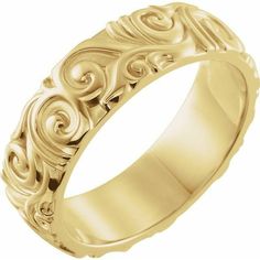 a gold wedding band with swirl designs on it