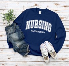 "Custom Nursing Sweatshirt, Customized Nursing Program University Sweater, Personalized Faculty College, School of Nursing, Comfort cotton standard USA size men's women's unisex available in 6 color ; Black, White, Navy, Sport Grey, Irish Green and Red. This Sweatshirt using USA standard size; S, M, L, XL, 2XL, 3XL. Sweatshirt Spec's Using Direct to Garment (DtG) for quality and durability print. * 8 oz./yd² (US) 13.3 oz./L yd (CA), 50/50 preshrunk cotton/polyester * Classic fit * Air jet yarn f Long Sleeve Letter Print Campus T-shirt, Long Sleeve Letter Print T-shirt For Campus, Relaxed Fit Long Sleeve T-shirt For Campus, Long Sleeve Relaxed Fit T-shirt For Campus, Long Sleeve Tops With Lettering For Campus, Relaxed Fit Lettering Tops For Campus, Varsity Long Sleeve T-shirt With Lettering, Cotton Campus Tops With Team Name, University Sweater