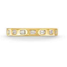 a yellow gold ring with three baguettes and four diamonds on the side, set in