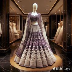 a mannequin dressed in a purple and white lehenga