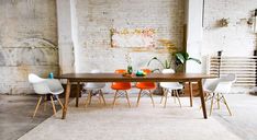 an image of a dining room setting with white chairs and wooden table in the foreground