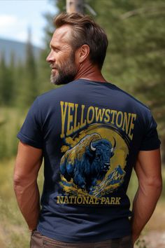 A man wearing a navy blue t-shirt with a bison print, the words Yellowstone National Park are displayed. National Park Shirt, Traffic Jam, Yellowstone National, Design Set, Yellowstone National Park, The Landscape, The Wild, Put On, National Park