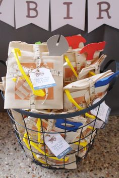 a basket filled with paper and scissors on top of a counter next to a sign