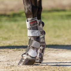 a close up of a horse's boots on the ground