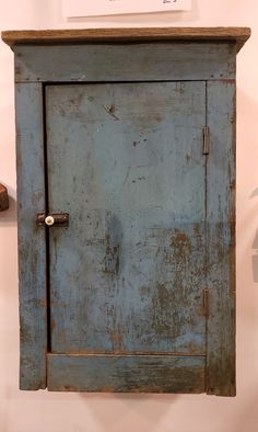 an old blue cabinet with the door open