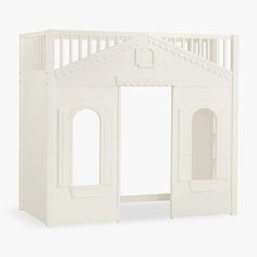 a white wooden doll house with doors and windows