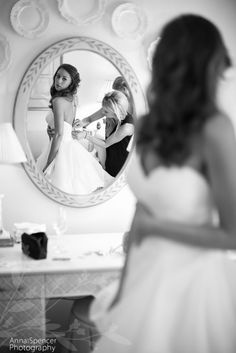 a woman standing in front of a mirror