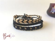 two bracelets sitting next to each other on a table