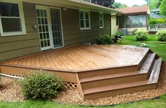 a wooden deck in front of a house