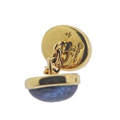 Pair of Trianon 18k gold cufflinks, with sapphire cabochons. DESIGNER: Trianon MATERIAL: 18k Gold GEMSTONES: Sapphire DIMENSIONS: Each cufflink top is 13mm x 11mm. MARKED/TESTED: Trianon , 18k. WEIGHT: 12.6 grams CONDITION: Estate Polished Yellow Gold Earrings For Business, Classic Yellow Gold Cabochons For Formal Occasions, Oval Yellow Gold Cabochons For Formal Events, Classic Yellow Gold Cabochons As A Gift, Designer Yellow Gold Cabochon Jewelry, Blue Classic Cabochons For Formal Occasion, Classic Blue Cabochons For Formal Occasion, Elegant White Gold Cabochons For Formal Occasions, Blue Formal Classic Cabochons