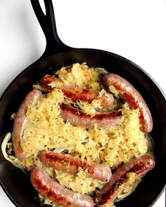 sausages and rice cooking in a skillet