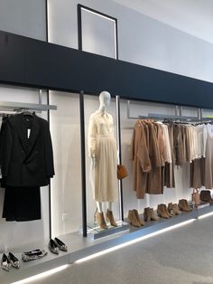 a display case filled with clothes and shoes