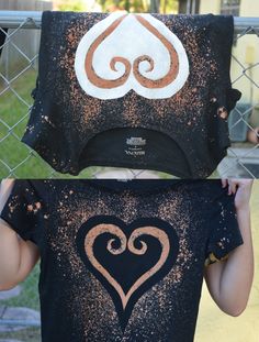 the back of a woman's t - shirt with two hearts painted on it