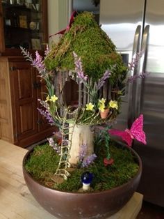 a bird house made out of moss and flowers