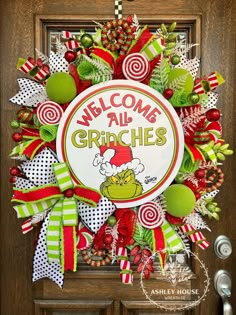 the grinch welcome wreath is hanging on the front door