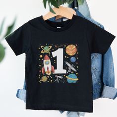 Welcome to Maddy & George Designs! We are excited to present our exclusive collection of baby t-shirts, each meticulously crafted to order. Unlike off-the-shelf products, every t-shirt is individually made with high-quality materials and careful printing techniques to ensure exceptional quality. Since each item is tailor-made for your little one, please allow 3-5 business days for us to prepare your order before shipping. The wait will be well worth it! **Product Information** Our baby t-shirts First Birthday Graphic Tee With Short Sleeves, Cotton T-shirt With Character Print For Birthday Gift, Short Sleeve Tops With Character Print For Birthday Gift, First Birthday Crew Neck Top With Character Print, Cotton Number Print T-shirt For Birthday, Cotton T-shirt With Number Print For Birthday, Graphic Tee For First Birthday With Short Sleeves, Number Print T-shirt For Summer, First Birthday Tops With Cartoon Print And Short Sleeves