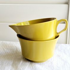 three yellow bowls stacked on top of each other