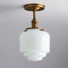 an old fashioned light fixture hanging from the ceiling