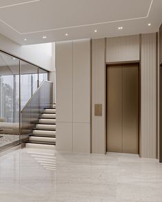 an empty lobby with marble flooring and stairs leading up to the second story door