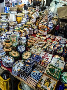 there are many plates and bowls on the table