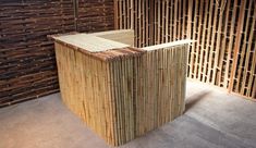 two wooden benches sitting next to each other in front of bamboo wall panels and flooring