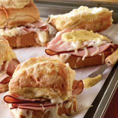 ham and cheese sandwich cut in half on a baking sheet