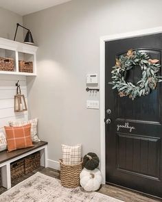 the entryway is decorated with wreaths, pillows and other items for fall decor