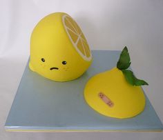 two yellow fruit shaped like lemons sitting on top of a blue plate next to each other