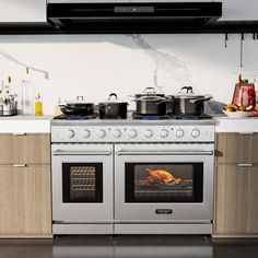 a stove top oven sitting inside of a kitchen