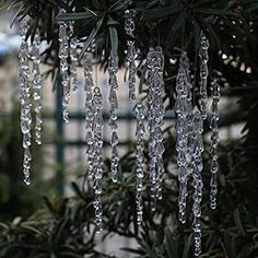 icicles hanging from the branches of a pine tree