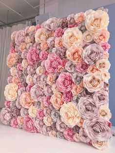 a large flower wall made out of paper flowers