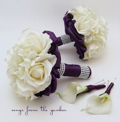 two bridal bouquets with purple ribbons and white flowers