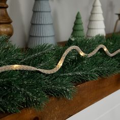 christmas decorations are lined up on a mantle