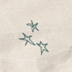 two green stars are drawn on the white paper with blue ink, and they appear to be flying in opposite directions