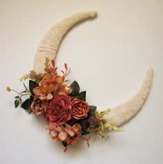 an antler with flowers and leaves on it