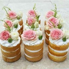 there are four cakes with flowers on top