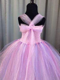 Fuzzy Duckling Design dresses ~ handcrafted for the little princess in your life. Our beautiful dresses feature a stretchy, crocheted bodice that is fully lined for both comfort and modesty. The full skirts sparkle and shine with three layers of high quality tulle in matte, shimmer, and glitter finishes. Satin ribbons, flowers, and jewels are added to make each dress something special. Our standard princess dresses are designed to be tea-length and should reach to approximately mid-calf on your Lavender Fitted Princess Dress For Dress-up, Pink Fitted Princess Fairy Dress, Handmade Fitted Pink Dress, Lavender Princess Dress For Dress-up, Fairy Style Pink Princess Wedding Dress, Lavender Princess Dress For Dress-up Occasions, Princess Style Lavender Fairy Dress For Party, Lavender Princess Dress For Party, Pink Princess Fairy Dress For Dress-up