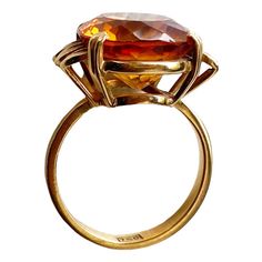 This classic 18K gold ring masterfully displays a magnificent Imperial Citrine quartz crafted in the shape of a large 06.2" x 0.5" x 0.3", weighing 6.5 grams. Size 6, ring size 1" h by 0.75" w by 0.50 " d The stone is set in a center prong style for eye-catching brilliance. This exquisite piece of jewelry is an ideal addition to any fine jewelry collection and provides excellent style and luxury. Citrine is more than just a beautiful gemstone; it carries a wealth of symbolism and cultural signif Luxury Hallmarked Topaz Ring For Formal Occasions, Gold Oval Crystal Ring For Formal Occasions, Luxury High Luster Gemstones For Formal Occasions, Luxury Amber Rings For Formal Occasions, Formal Citrine Diamond Ring With Prong Setting, Oval Citrine Jewelry For Formal Occasions, Gold Faceted Crystal Ring For Formal Occasions, Luxury Amber Jewelry For Formal Occasions, Oval Topaz Art Deco Ring For Formal Occasions