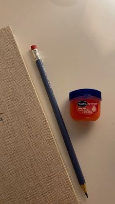 a pencil and eraser sitting next to a notebook