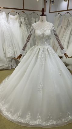 a white wedding dress on display in a store