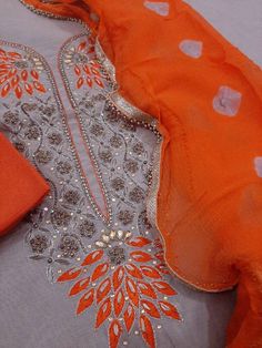 Item Overview ATHARVA Hand Embroidery Salwar Kameez w/Beautiful Embroidered Neck in Grey/Orange Dupatta/Customized Stitching/Bridal Trousseau/ Dno. CH1297 Fabric: * Shirt: Chanderi Silk - 2.5 Mts - Grey - Neck Embroidery * Dupatta: Chiffon Chinnon 2.5 Mts - Orange * Bottom Santoon Silk Salwar 2.5 Mts. Excusive Hand Embroidered Party Wear Punjabi Suit. Customization: * Fabrics Customization: Designs Can be made in different Fabrics. * Color Customization: Designs Can be made in different Colors. Punjabi Suits, Salwar Kameez, Different Fabrics, Party Wear, Hand Embroidered, Hand Embroidery, Chiffon, Orange, Silk