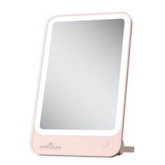 a pink mirror sitting on top of a table