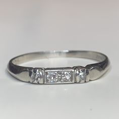 an old diamond ring is sitting on a table