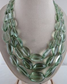 PRODUCT DETAILS LINE 3 / CTS 1172.50 NATURAL GREEN AMETHYST TUMBLE  EXCELLENT COLOR AND QUALITY  BIGGEST SIZE OF THE BEADS IS 30MM SMALLEST SIZE OF THE BEADS IS 19MM INNER LENGTH OF THE NECKLACE IS 21 INCHES  OUTER LENGTH OF THE NECKLACE IS 16 INCHES  ATTACHED TO SIZABLE SILK CORD  BEST BARGAIN PRICE OFFERED NOTE - #You will receive the same product you see in picture. #DEAR BUYERS PLEASE FEEL FREE TO ASK QUESTIONS  #WE WILL BE GLAD TO ANSWER & SOLVE QUERY REGARDING THIS PRODUCTS #RETURN POLICY Every piece of jewellery and inputs (gem stones, diamonds, making and setting) is tested by our team of experts and experienced artisans to generate maximum satisfaction to our valued customers. Customer satisfaction is our primary goal. All information about the material used in jewellery, except f Fine Necklace, Amethyst Tumbled, Round Bead Necklace, Silk Cord, Amethyst Beads, Green Amethyst, Multi Strand Necklace, Rock Crystal, Strand Necklace