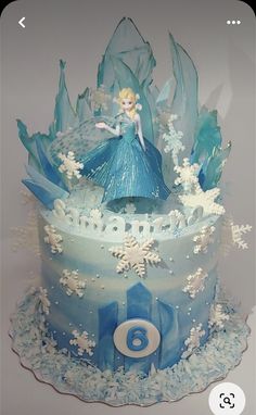 a frozen princess birthday cake with frosting and decorations